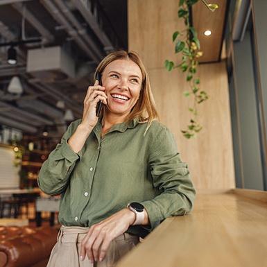 Woman smiling while talking on cellphone