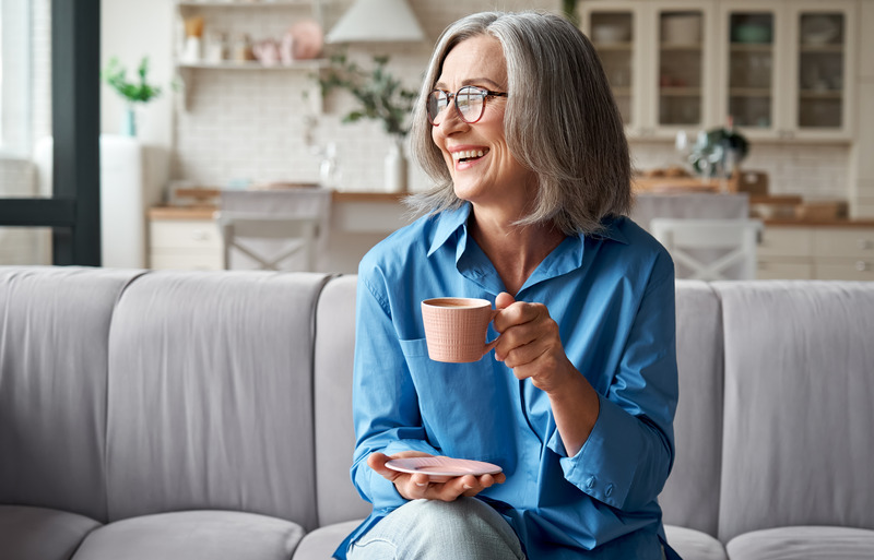 Older patient smiling with their Invisalign aligner